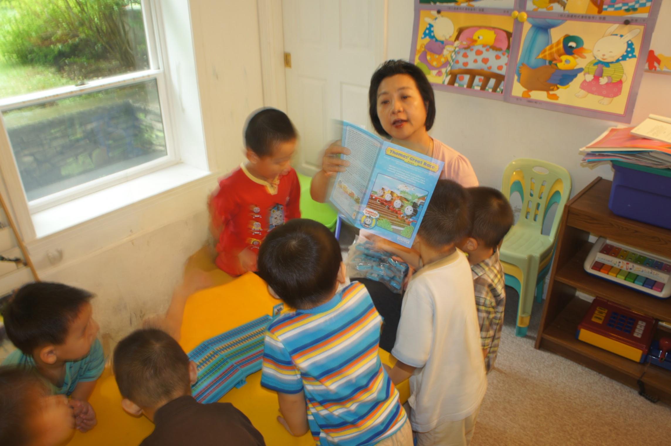 Ms. Fei reading a story with children